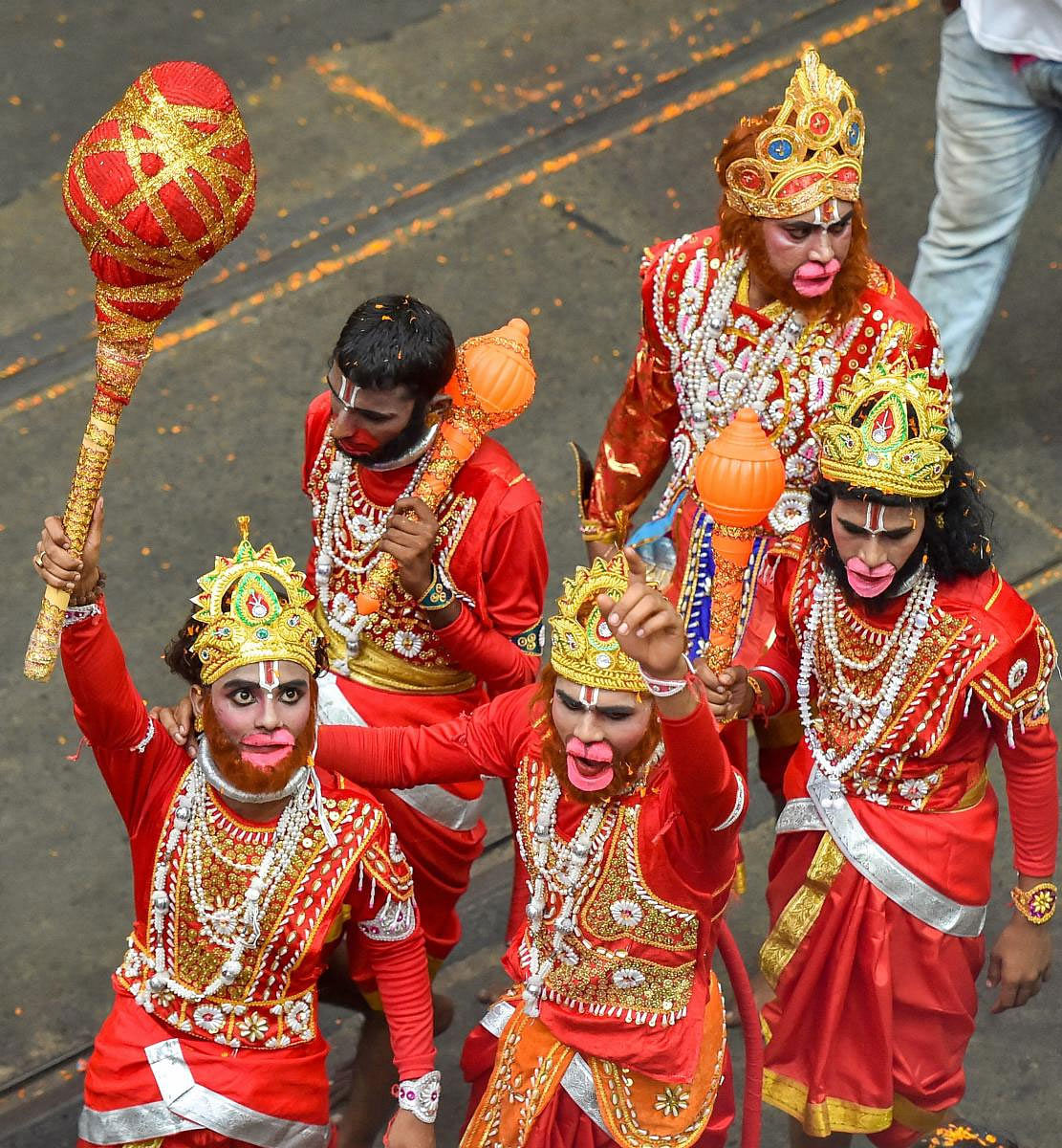 Artists take part in BJP National President Amit Shah's election roadshow for the Lok Sabha elections, in Kolkata, Tuesday, May 14, 2019. (PTI Photo)