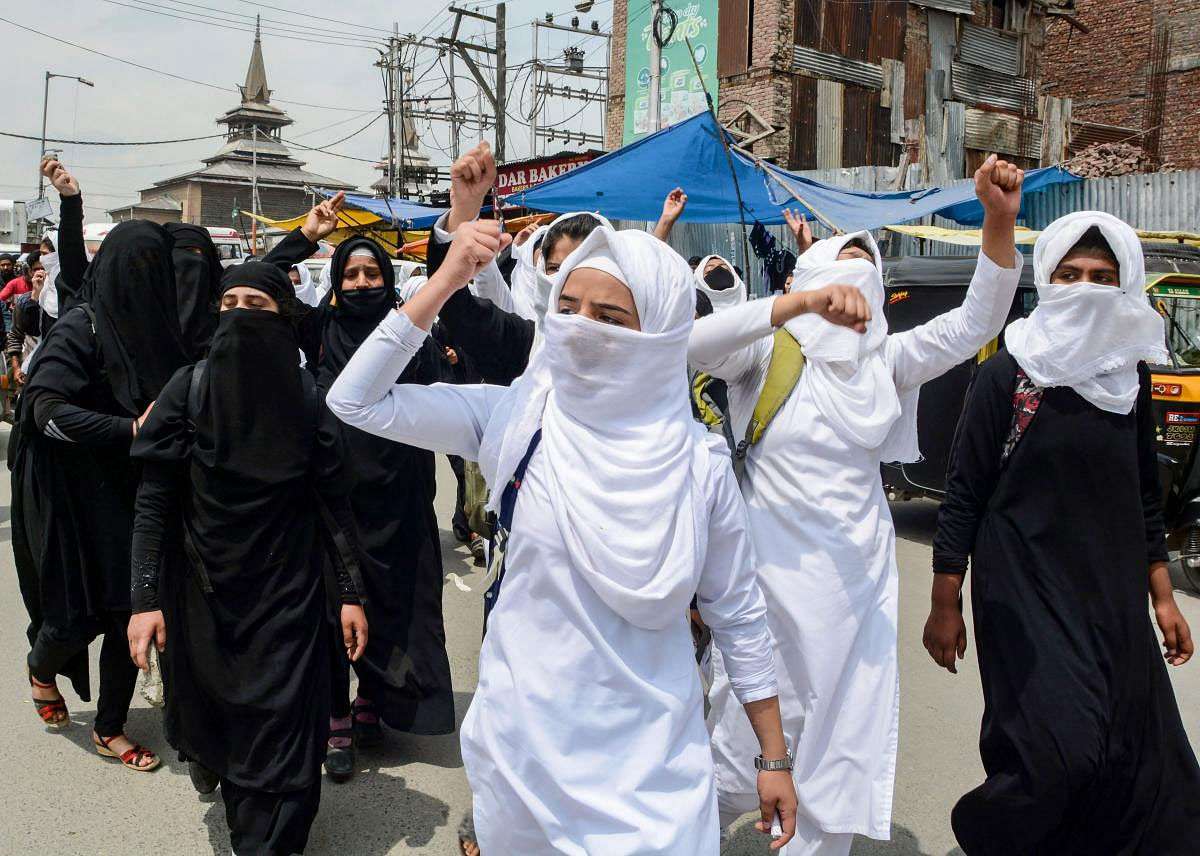 College students raise slogans during a protest against the alleged rape of a three-year-old girl by a local in Bandipora district of Jammu and Kashmir, at Nowhatta in Srinagar, Wednesday, May 15, 2019. The authorities have ordered suspension of class work in many schools and colleges of valley as a precautionary measure. (PTI Photo)