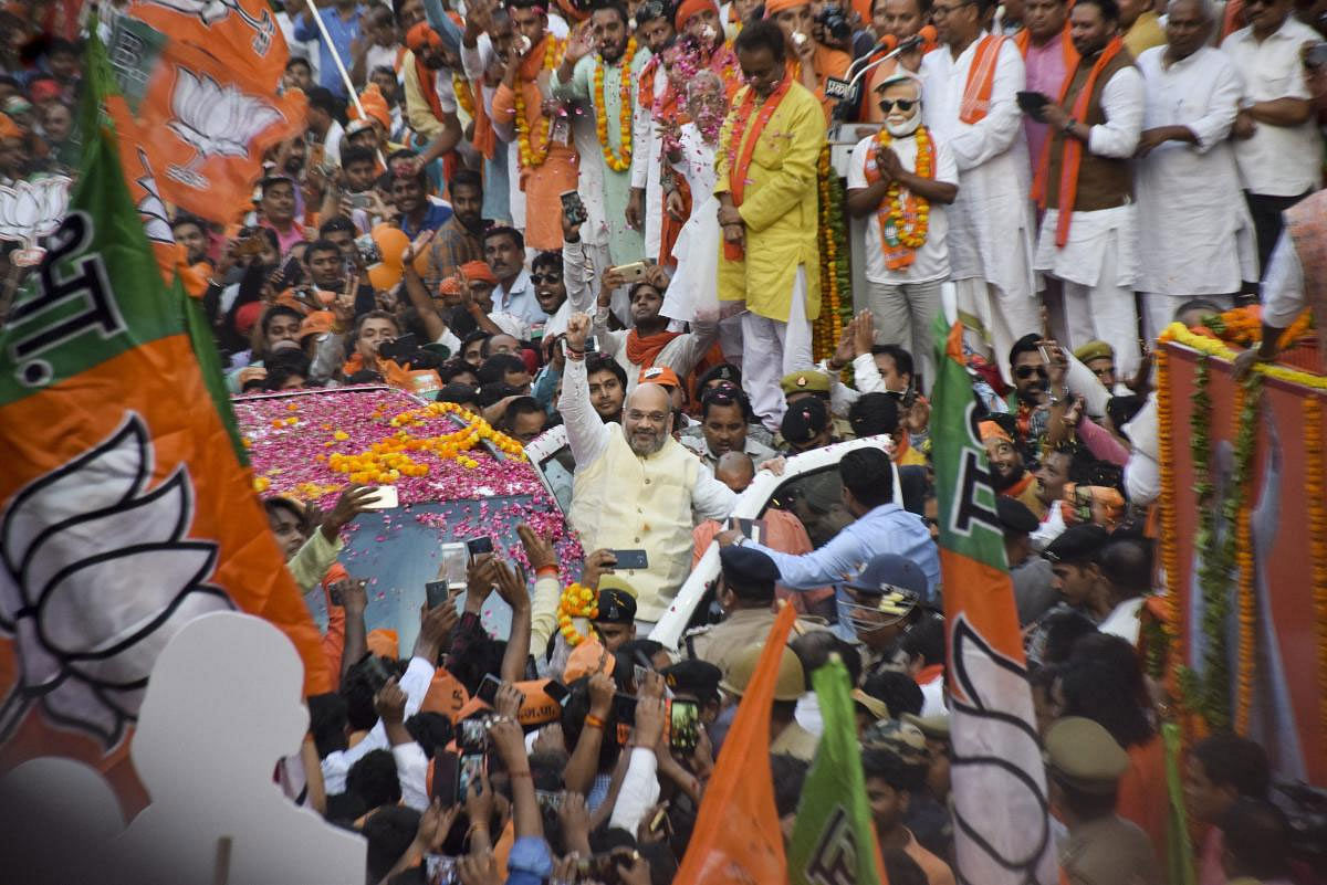 BJP National President Amit Shah along during an election campaign roadshow for the seventh and last phase of Lok Sabha polls, in Gorakhpur, Thursday, May 16, 2019. (PTI Photo)