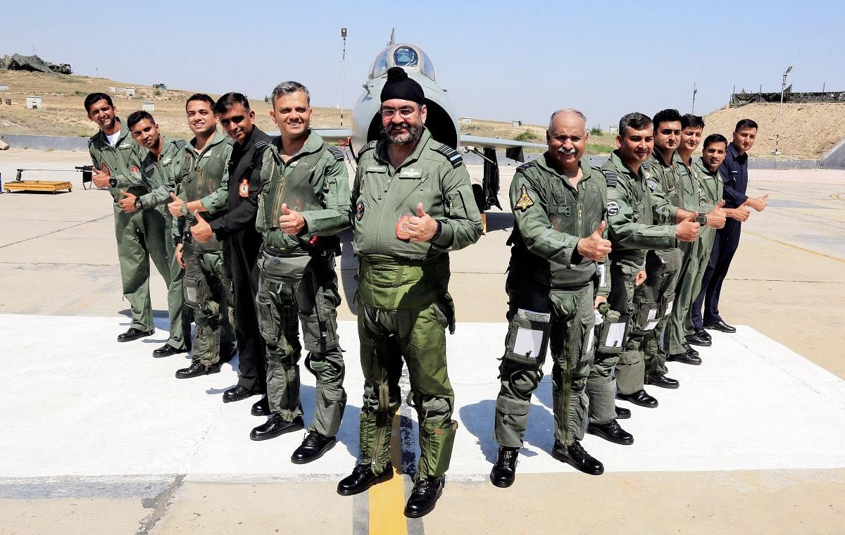 Air Chief Marshal Birender Singh Dhanoa and his colleagues before flying MiG-21 planes in a 'missing man' formation, an aerial salute to honour martyr Squadron Leader Ajay Ahuja, at Bhisiana Air Force station, in Bathinda. PTI Photo