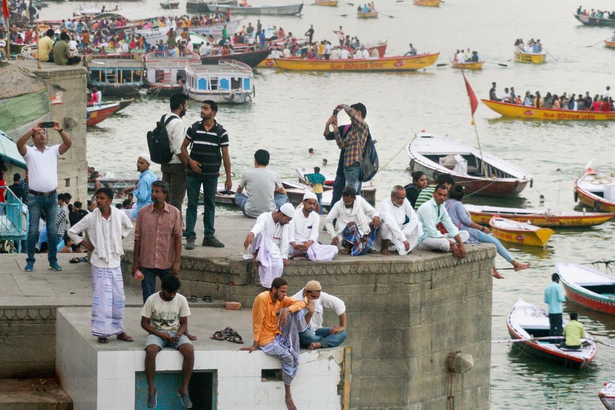 Visitors sit at the bank of River Ganga on a hot, summer day, in Varanasi, Tuesday, June 11, 2019. (PTI Photo)