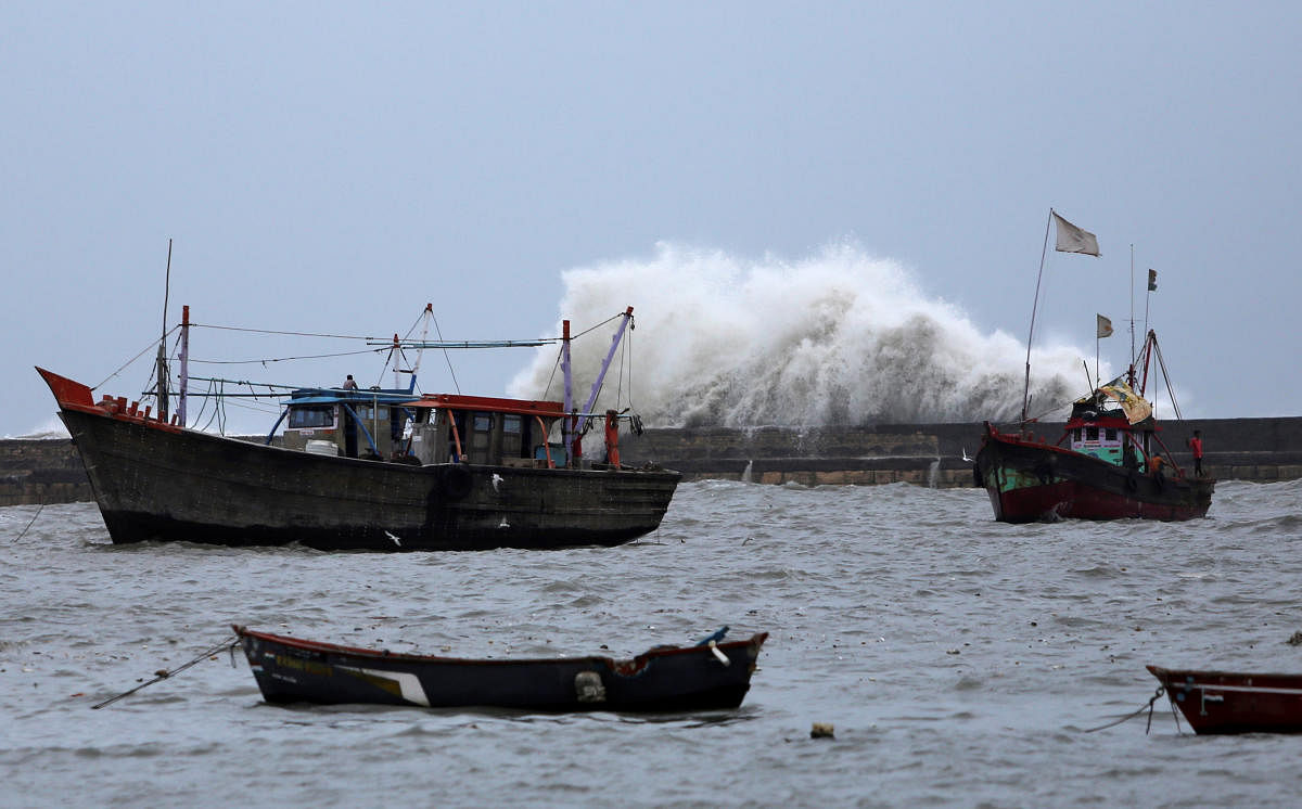 Waves crash against the jetty at a fishing harbour ahead of the expected landfall of Cyclone Vayu at Veraval, India, June 12, 2019. REUTERS/Amit Dave