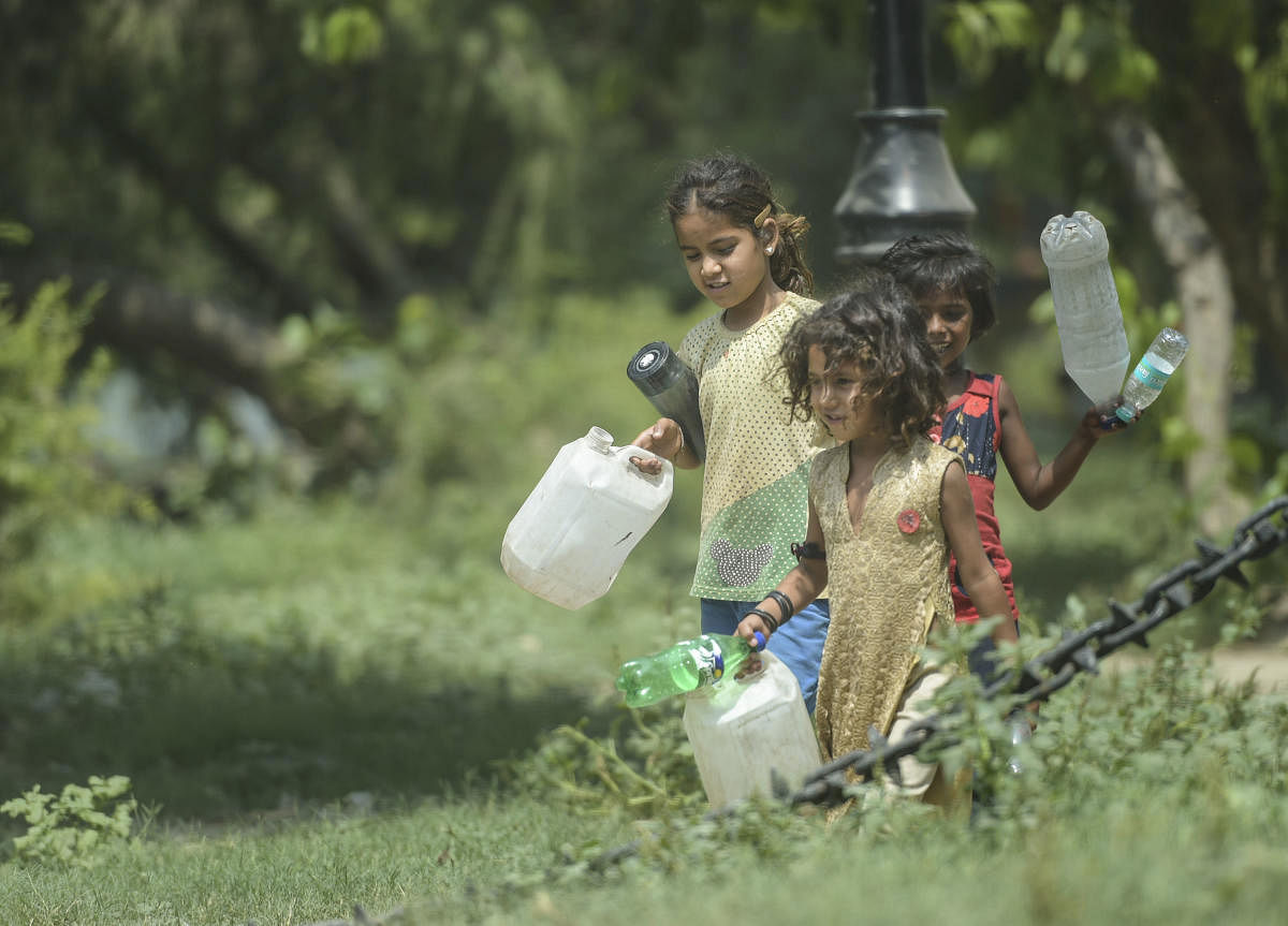 Children on their way to collect water on a hot summer day, in New Delhi, Wednesday, June 12, 2019. (PTI Photo/Vijay Verma)
