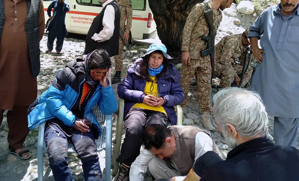 In this photo provided by Gilgit Baltistan regional police department, mountaineers receive initial treatment following their rescue, at a helipad in the town of Imit, Ghizer district of Gilgit Balistan region, Pakistan, Tuesday, Jun 18, 2019. AP/PTI