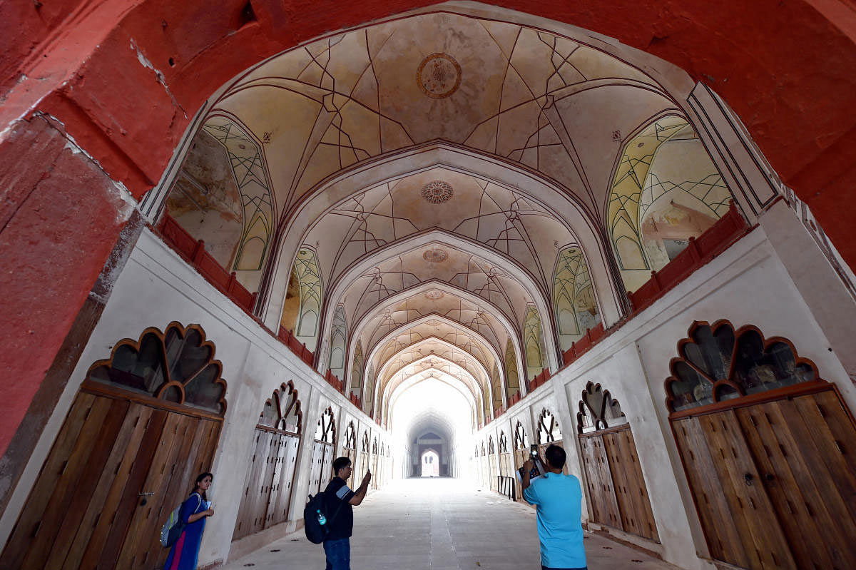Media persons take photographs of the Red Fort entrance during its ongoing restoration and conservation work, in New Delhi, Monday, June 24, 2019. (PTI Photo)