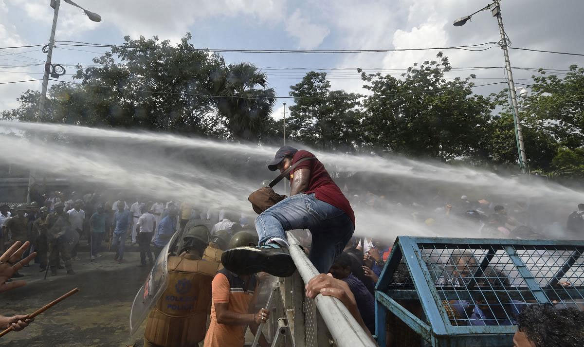 Police uses water cannon to disperse the government primary teachers protesting against the state government demanding the revival of their salaries, in Kolkata, Monday, June 24, 2019. (PTI Photo)