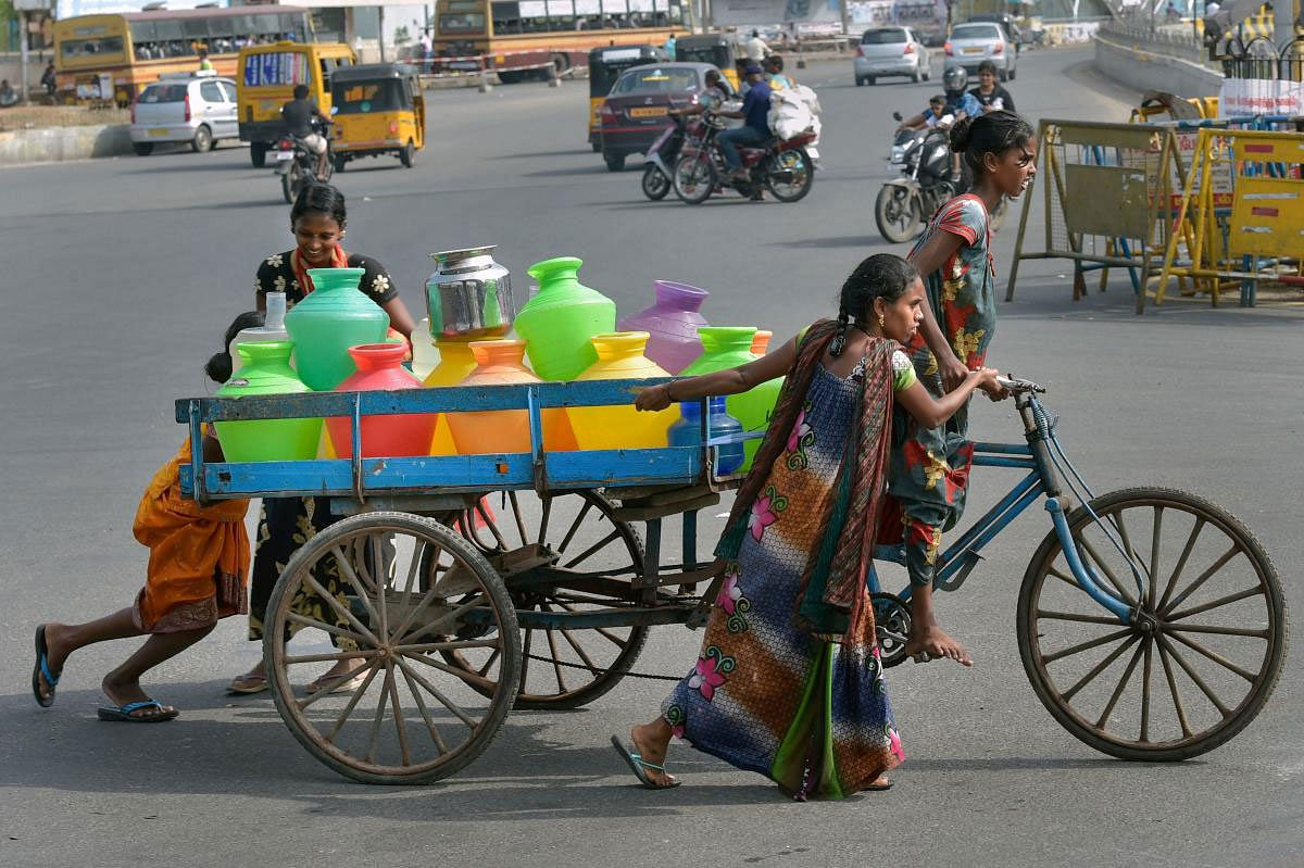 Women push a cart containing vessels filled with water from a tanker following an acute water shortage, in Chennai, Wednesday, June 26, 2019. (PTI Photo)