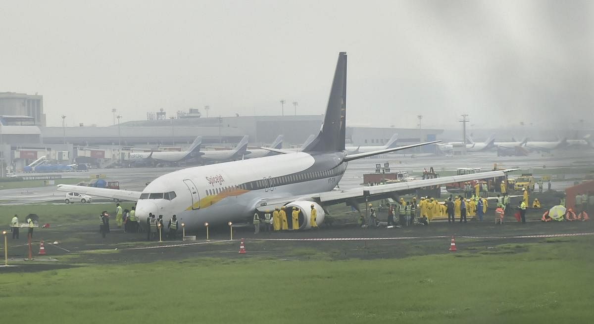 A SpiceJet plane from Jaipur overshot the runway while landing at Mumbai airport amid heavy rain on Monday.  (PTI Photo)