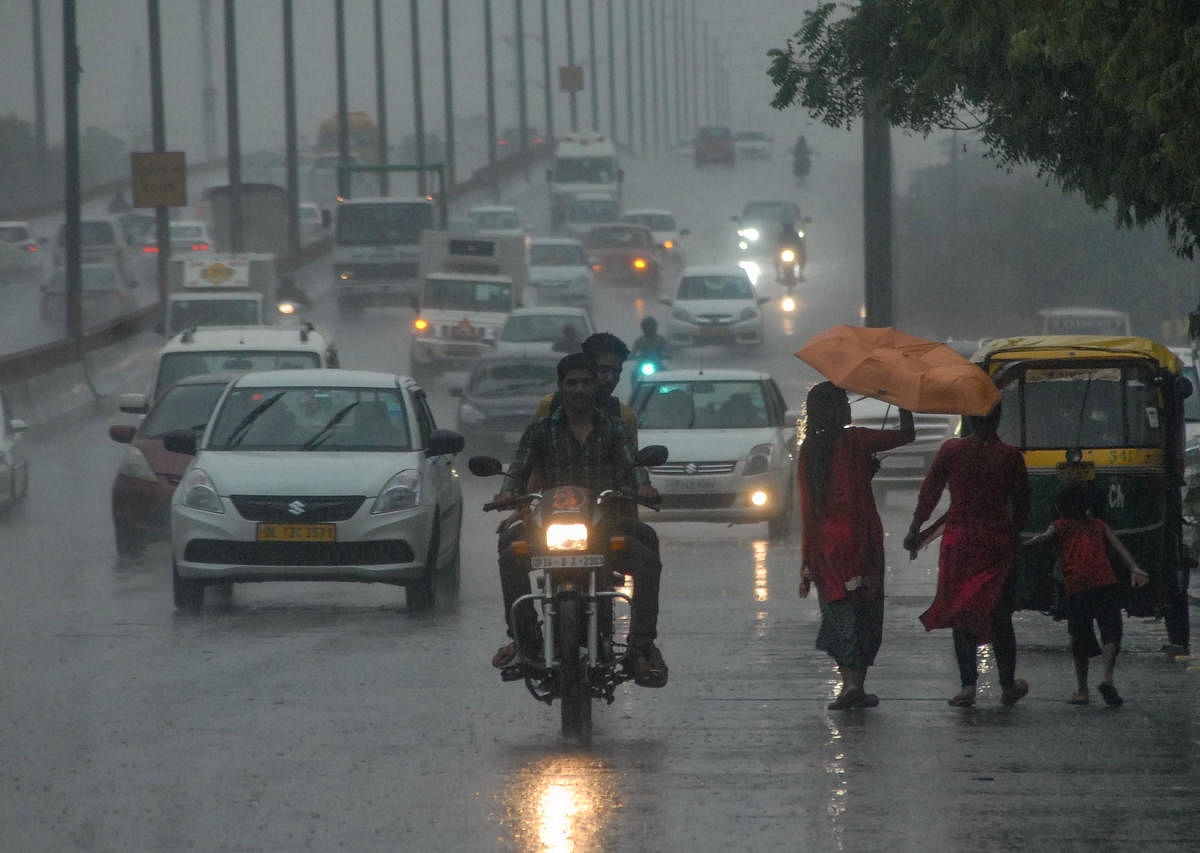 Commuters travel during heavy pre-monsoon rainfall, in Noida, Friday, July 5, 2019. (PTI Photo)