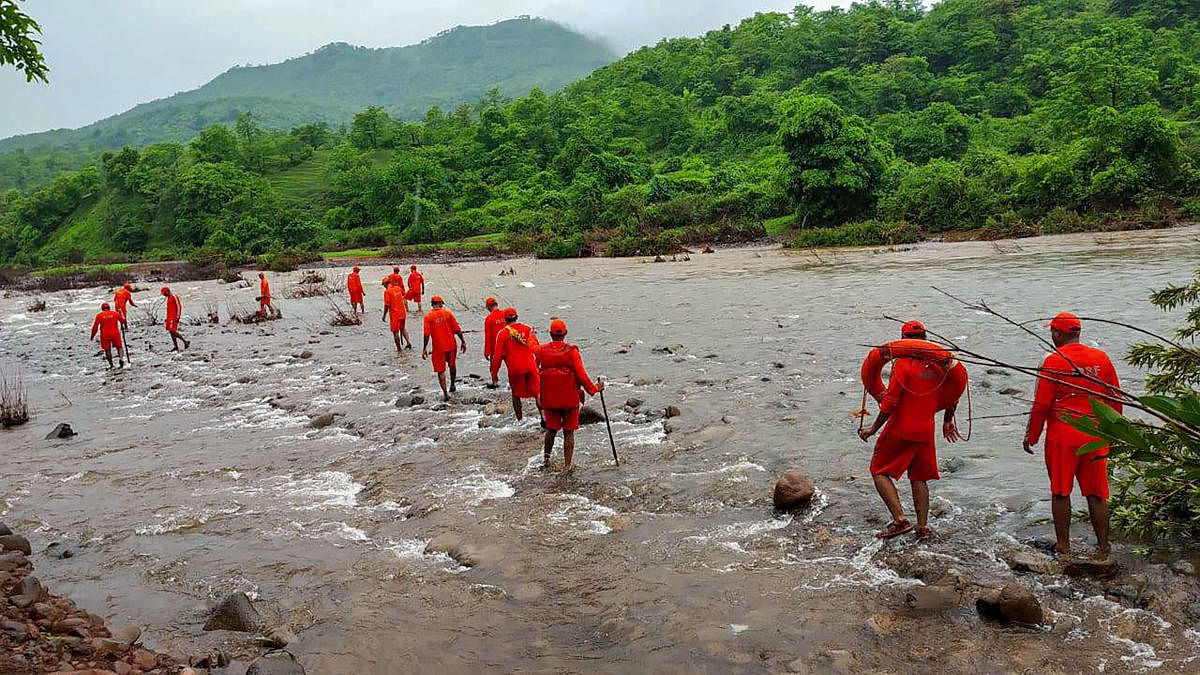 NDRF personnel conduct search operation for missing villagers, after Tiware dam breached following incessant rains, in Ratnagiri, Thursday, July 4, 2019. (PTI Photo)