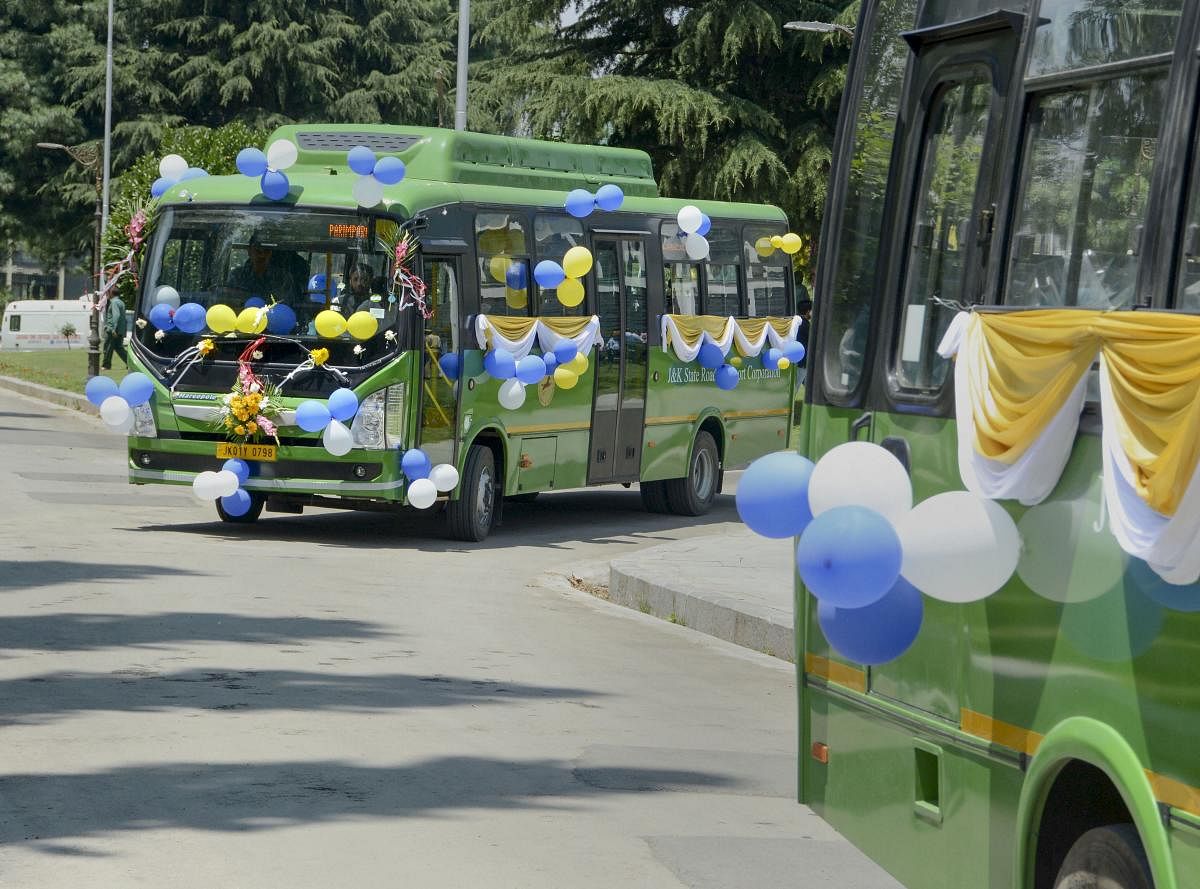 The first set of 'electric buses' ply on the Boulevard Road at the banks of Dal Lake after its inauguration by Union Minister for Heavy Industries and Public Enterprises Arvind Ganpat Sawant and Governor of Jammu and Kashmir Satya Pal Malik, in Srinagar. (PTI Photo)