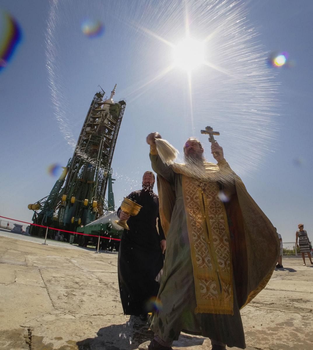 An Orthodox priest conducts a blessing service in front of the Soyuz FG rocket at the Russian leased Baikonur cosmodrome, Kazakhstan. (AP/PTI Photo)