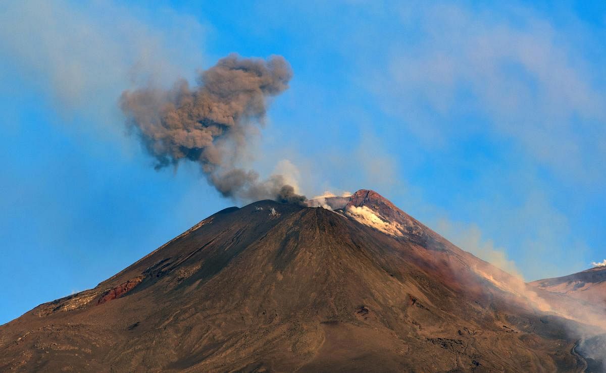 Smoke billows from Mount Etna volcano, the largest of Italy's three active volcanoes, near the Sicilian town of Catania, southern Italy. (AP/PTI Photo)