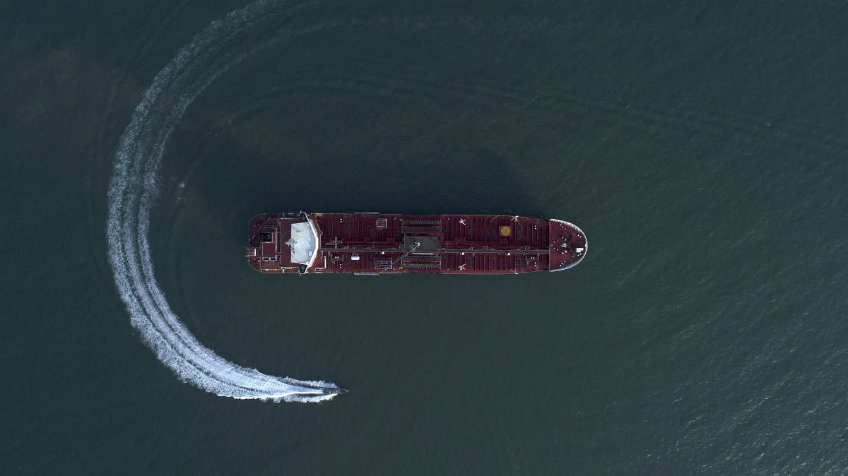 An aerial view shows a speedboat of Iran's Revolutionary Guard moving around the British-flagged oil tanker Stena Impero which was seized in the Strait of Hormuz on Friday by the Guard, in the Iranian port of Bandar Abbas. (AP/PTI Photo)