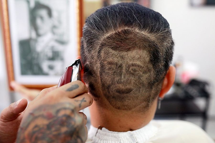Mitree Chitinunda gets a haircut in the shape of Thai King Maha Vajiralongkorn, to mark King's 67th birthday, in a barbershop at Bangkok, Thailand. (Reuters)