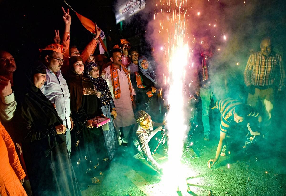 Varanasi: Muslim women celebrate after the triple talaq bill was passed in the Rajya Sabha, in Varanasi. (PTI Photo)