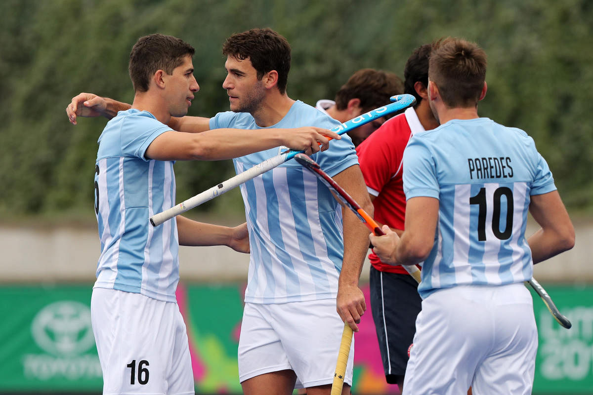 Field Hockey - XVIII Pan American Games - Lima 2019 - Field Hockey - Men Preliminaries Pool MA - Argentina v Chile - Hockey Field, Lima, Peru. Argentina's Jose Leandro Tolini celebrates with Ignacio Horacio Ortiz and Matias Enrique Paredes after scoring their first goal. (Reuters Photo)