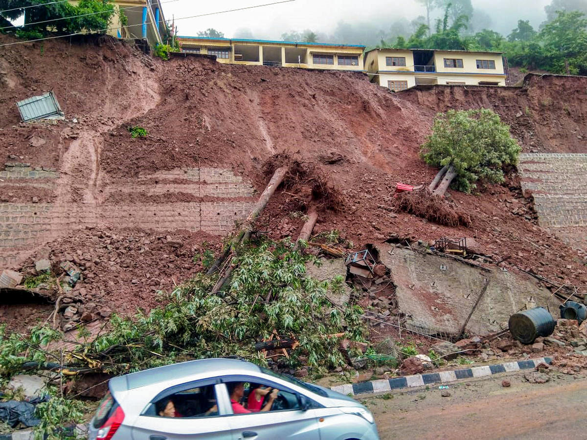 A school building lies on an edge of a hillock after a landslide following monsoon rain, in Solan district of Himachal Pradesh. PTI