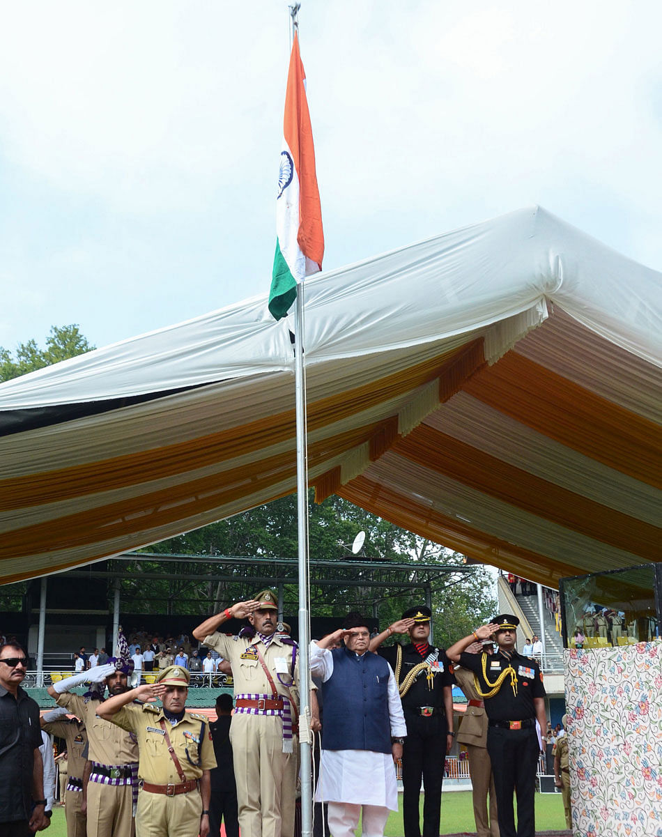 Satya Pal Malik (bottom C), Governor of Jammu and Kashmir state, salutes during a ceremony to celebrate India's 73rd Independence Day, which marks the end of British colonial rule, in Srinagar on August 15, 2019. (Photo by STR/AFP)