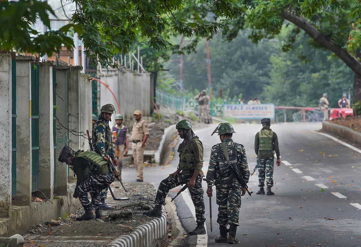 Security personnel inspect the area near Sher-e-Kashmir Cricket Stadium, in Srinagar, Thursday, Aug 15, 2019. (PTI Photo)