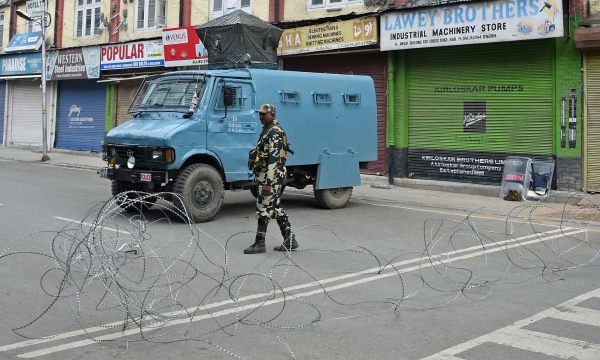 A member of the Indian security forces stands guard during a lockdown in Srinagar on August 16, 2019, after the Indian government stripped Jammu and Kashmir of its autonomy. (AFP)