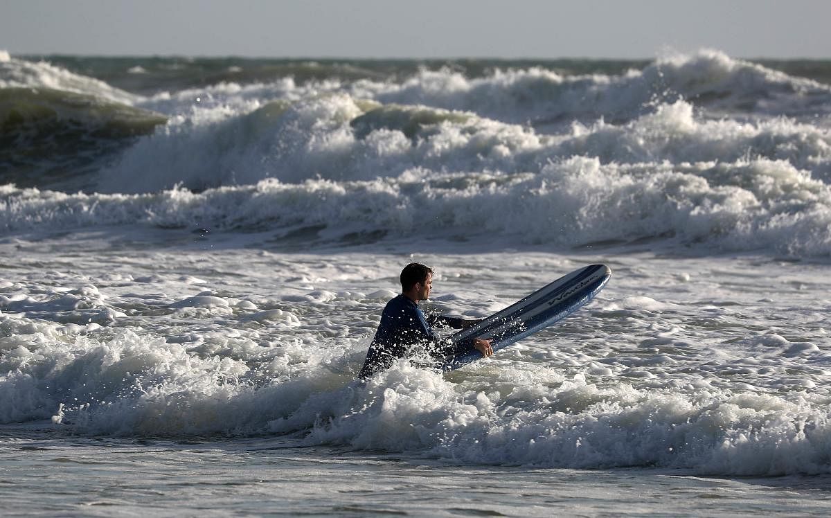 A surfer navigates waves and currents as the threat of Hurricane Dorian looms on September 1, 2019 in Ormond Beach, Florida.(AFP Photo)