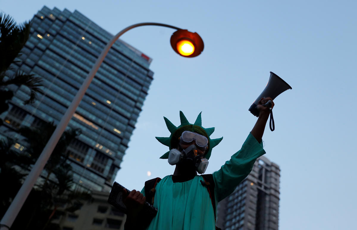 A protestor dressed as the Statue of Liberty, attends a protest in Central, Hong Kong, China. (Photo by Reuters)