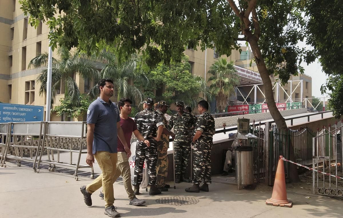 Security personnel guard outside the Jai Prakash Narayan Apex Trauma Centre of AIIMS, in New Delhi. A trial court hearing the Unnao rape case is holding in-camera proceeding inside the trauma centre to record testimony of the victim of the case. PTI