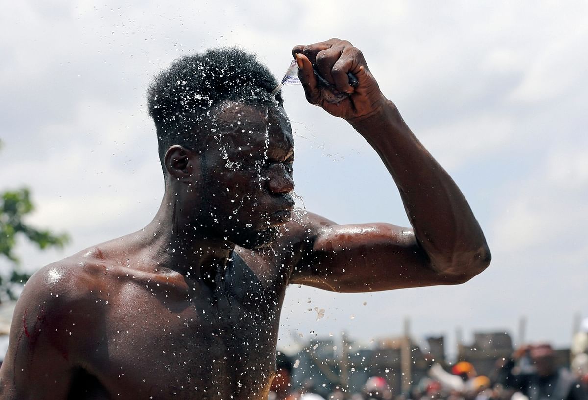 A Dambe boxer pours water on his head at the ancient brutal martial art of Dambe boxing, associated with Hausa people of West Africa
