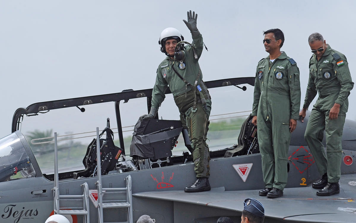 Defence Minister Rajnath Singh waves after flying the Tejas fighter aircraft from the HAL airport in Bengaluru on Thursday. (DH Photo/Pushkar V)
