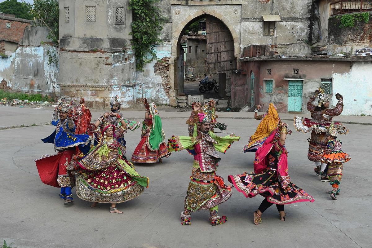 Folk dancers participate in a full dress rehearsal ahead of Navratri festival, in front of the ancient Khan Jahan Darwaja, in Ahmedabad. (AFP Photo)