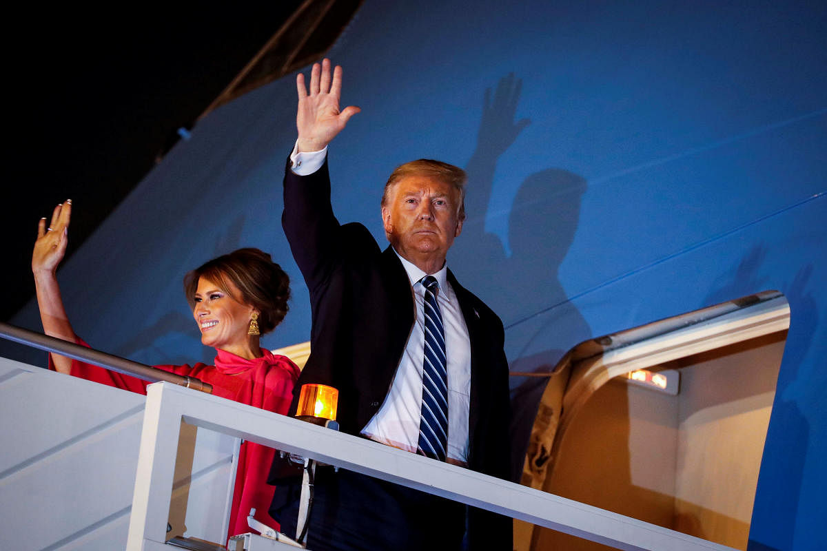 U.S. President Donald Trump and first lady Melania Trump wave as they board Air Force One as they conclude their two day visit to India, at Air Force Station Palam in New Delhi. (Reuters photo)