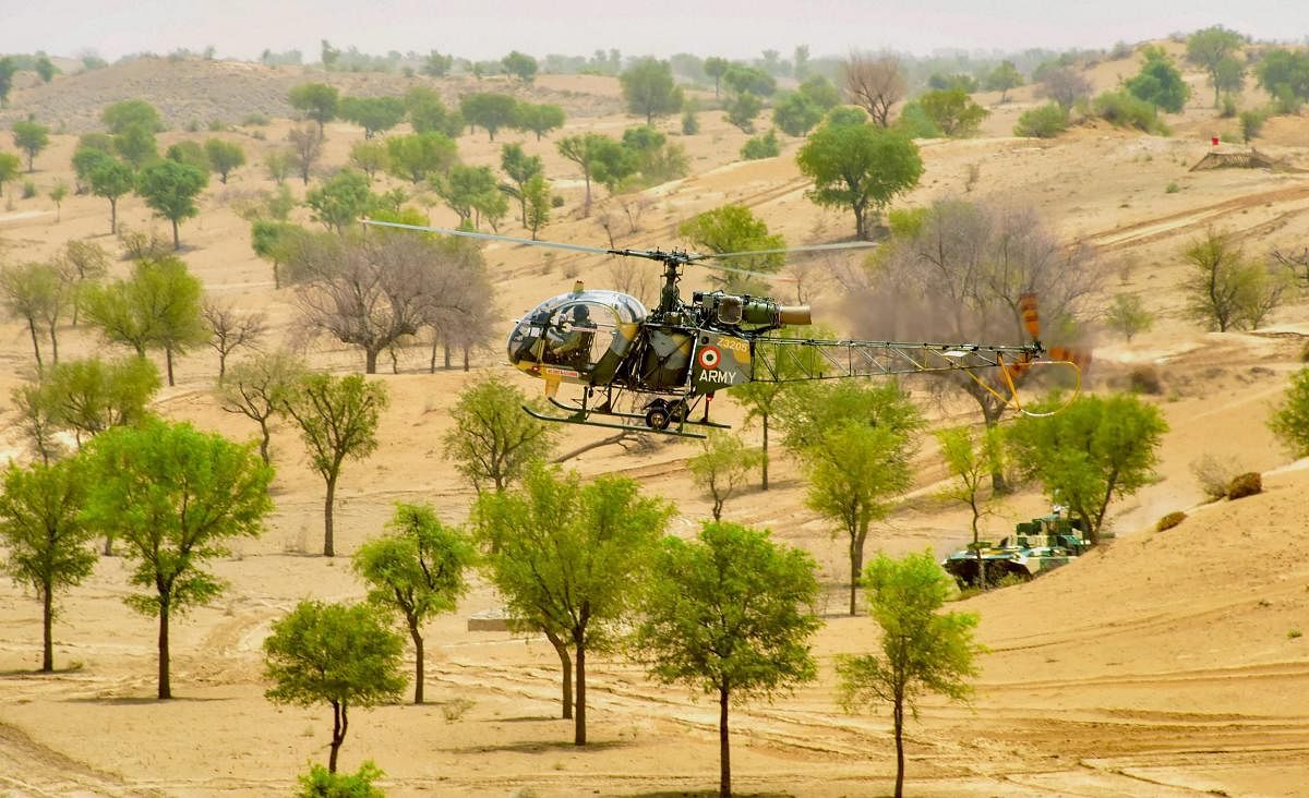 An army chopper during 'Vijay Prahar' military exercise at Mahajan Field Firing Range near Bikaner in Rajasthan on Wednesday. PTI