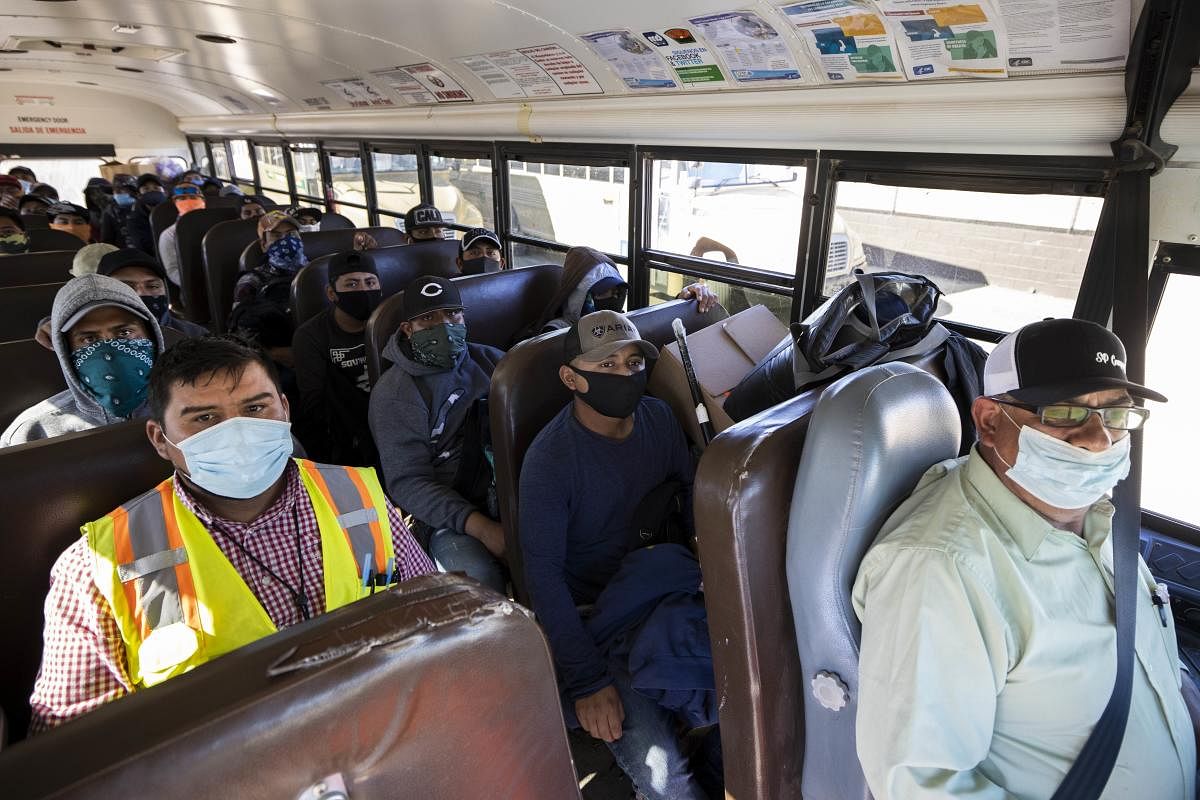Farm laborers from Fresh Harvest working with an H-2A visa ride the bus. (AFP Photo)
