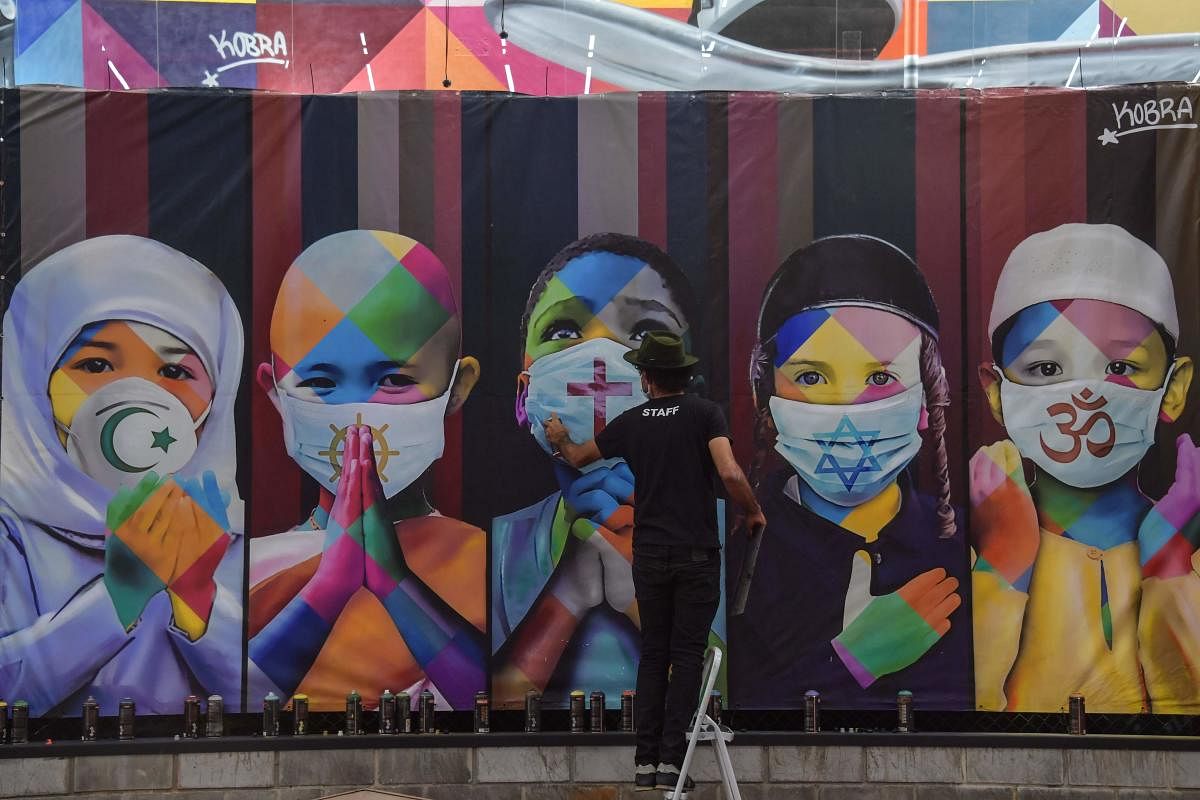 Brazilian mural artist Eduardo Kobra works on his recent work