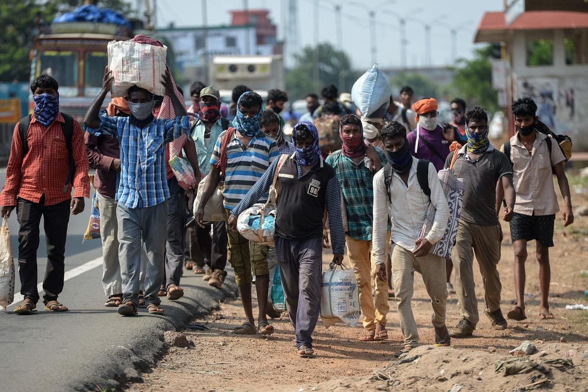 Migrant workers walk along a road as their return to their home towns in Jharkhand. (AFP Photo)