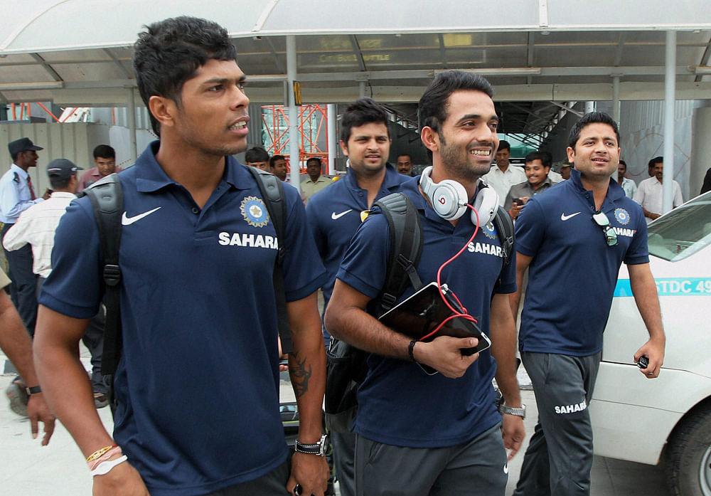 Cricketer Ajinkya Rahane, Umesh Yadav, Piyush Chawla and Suresh Raina on their arrival at the airport in Bengaluru on Tuesday for the 2nd Test match against New Zealand. PTI