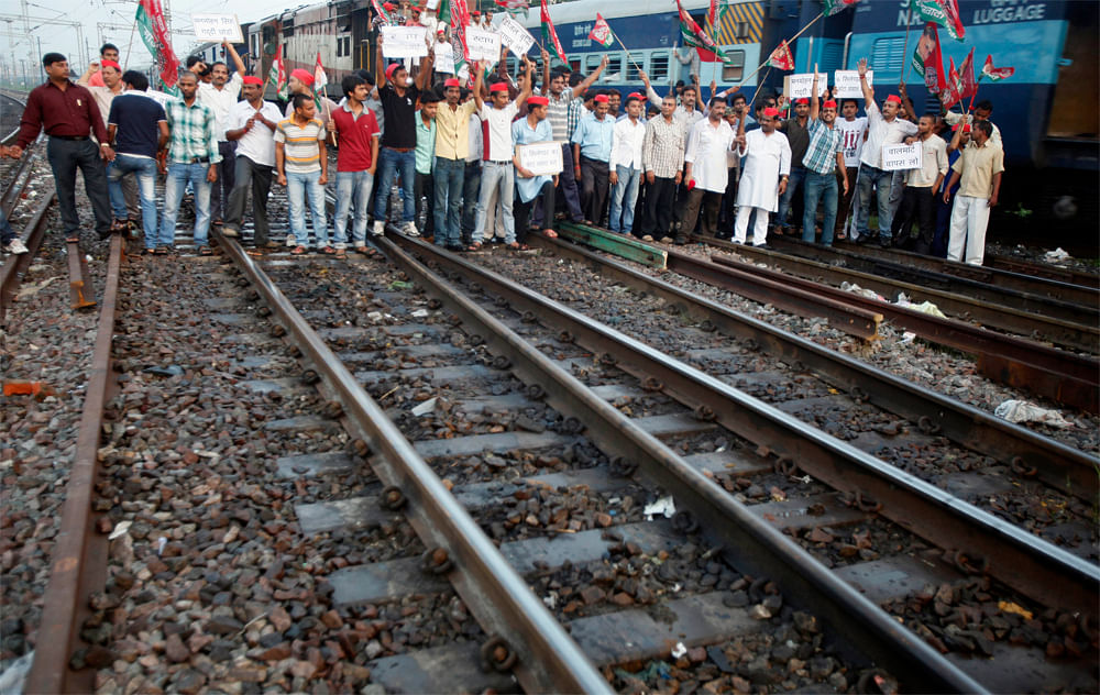 Samajwadi Party activists shout slogans during a protest along railway tracks in Allahabad, India, Thursday, Sept. 20, 2012. Angry opposition workers have disrupted train services as part of a daylong strike in India to protest rising diesel prices a...