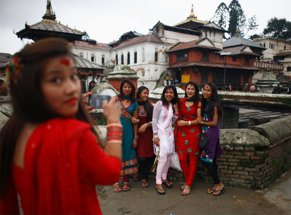 Nepalese women pose for a picture during the Rishi Panchami festival, in Kathmandu September 20, 2012. Rishi Panchami is observed on the last day of Teej when women worship Sapta Rishi (Seven Saints) to ask for forgiveness for sins committed during t...