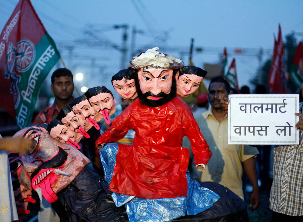 Samajwadi Party activists hold an effigy representing Indian Prime Minister Manmohan Singh and his cabinet colleagues before burning it during a protest along railway tracks in Allahabad, India, Thursday, Sept. 20, 2012. Angry opposition workers have...