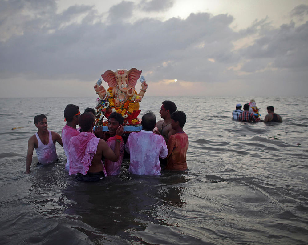 Devotees carry a statue of the Hindu god Ganesh, the deity of prosperity, into the Arabian Sea on the first day of the ten-day-long Ganesh Chaturthi festival in Mumbai September 20, 2012. Ganesh idols are taken through the streets in a procession acc...