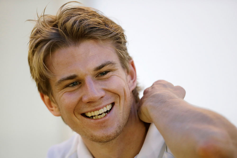 Force India Formula One driver Nico Hulkenberg of Germany smiles as he rests at the team's suite at the paddock of Marina Bay Street Circuit ahead of the Singapore F1 Grand Prix September 20, 2012. REUTERS