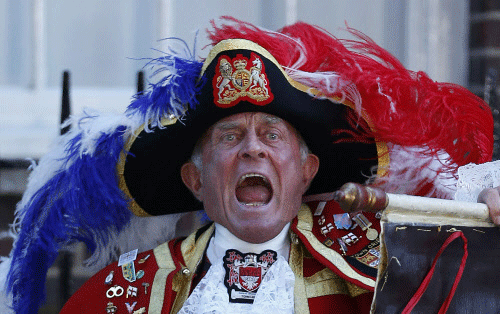 Tony Appleton, a town crier, announces the birth of the royal baby,  outside St. Mary's Hospital exclusive Lindo Wing in London, Monday, July  22, 2013. Palace officials say Prince William's wife Kate has given  birth to a baby boy. The baby was born...