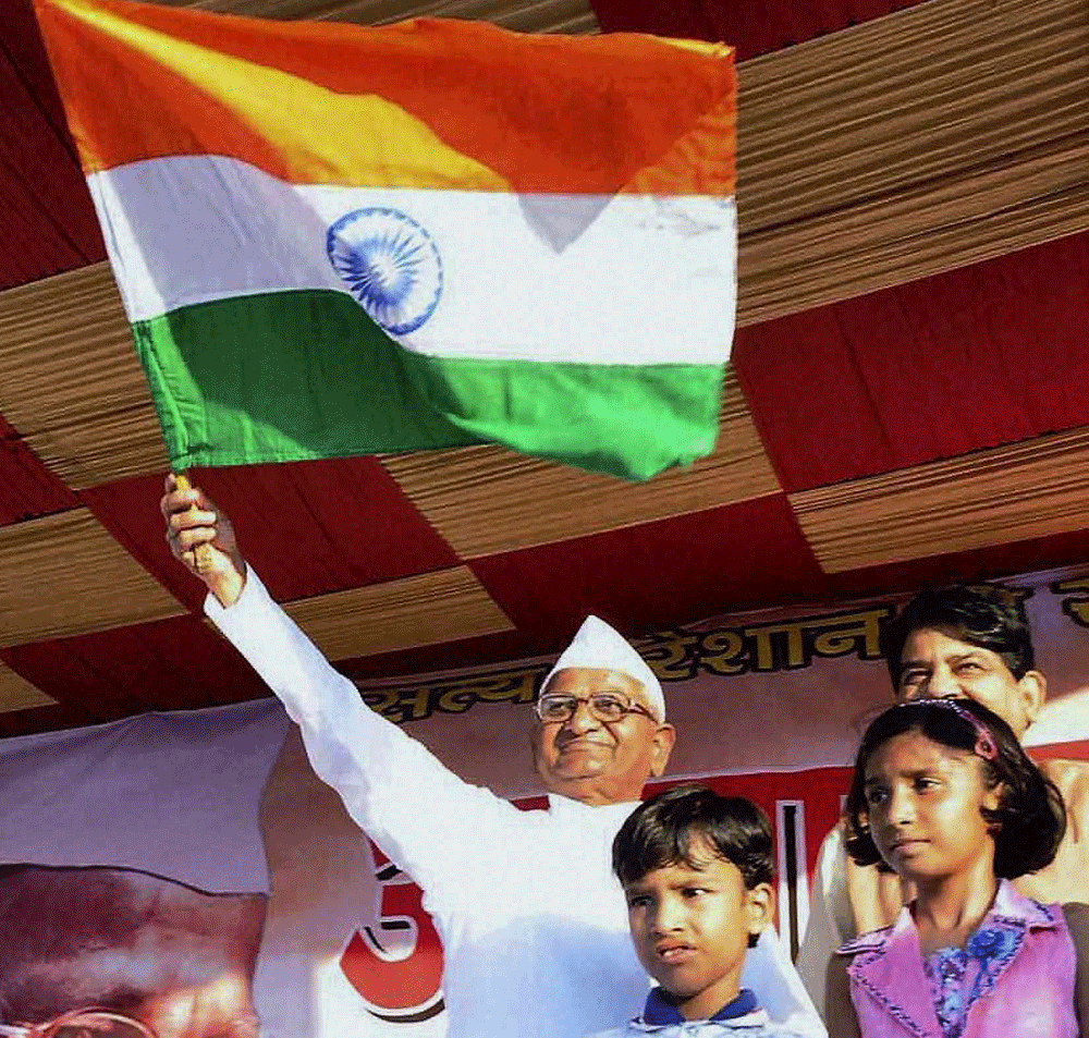Social activist Anna Hazare waves a tricolour with children during his Jantantra Yatra in Moradabad on Tuesday. PTI Photo