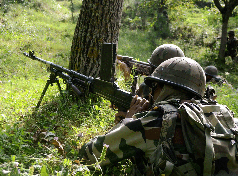 Army soldiers take position during an encounter with Jaish-e-Mohammad militants at Garewad Lolab in Kupwara district on Tuesday. Top most commander of JeM Qasir Yasir was killed in the encounter. PTI Photo