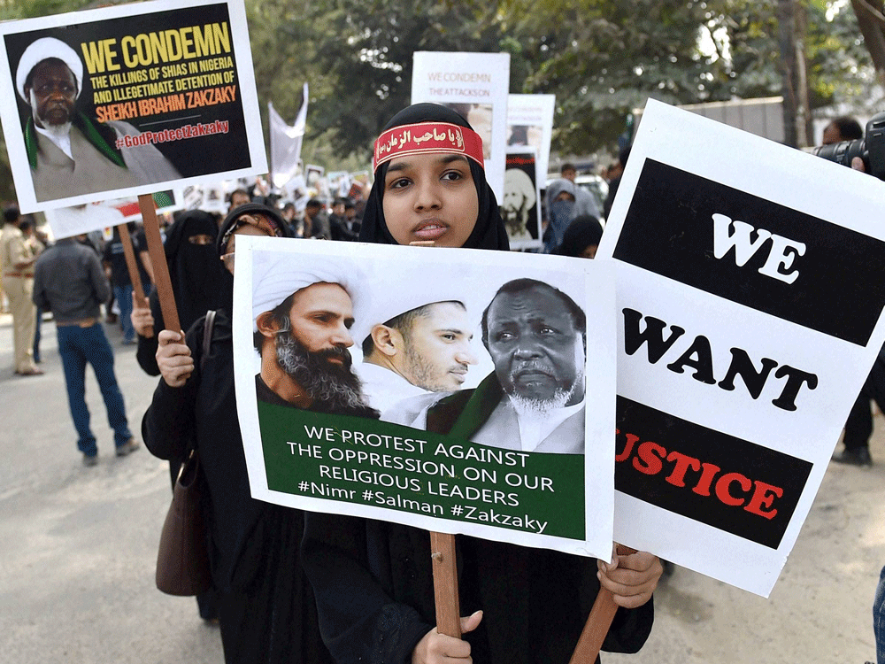 Shia Muslims hold placards at a protest to condemn the killing of Muslims and arrest of Shia leader Ayatollah Sheikh Ibrahim Zakzaky in Nigeria by the Nigerian Army, in Bengaluru on Friday. PTI Photo.