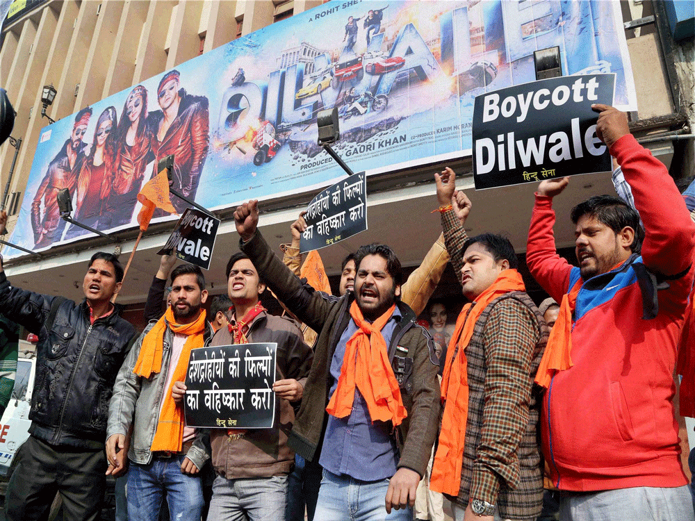  Hindu Sena activists protest against actor Shaharukh Khan's film 'Dilwale' in New Delhi on Friday. PTI Photo.