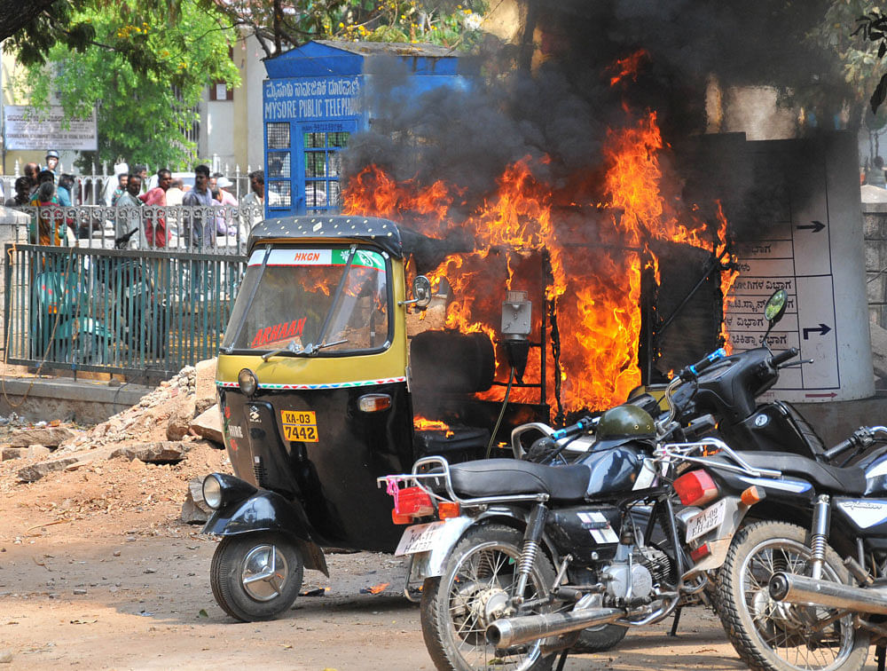 Auto rickshaw belonged to Noorulla of Udaygiri parked inside of K R Hospital was fired by unknown people during the protest as part of Mysuru Bandh, at K R Hospital in Mysuru on March 14, 2016 -Photo / PRASHANTH H G