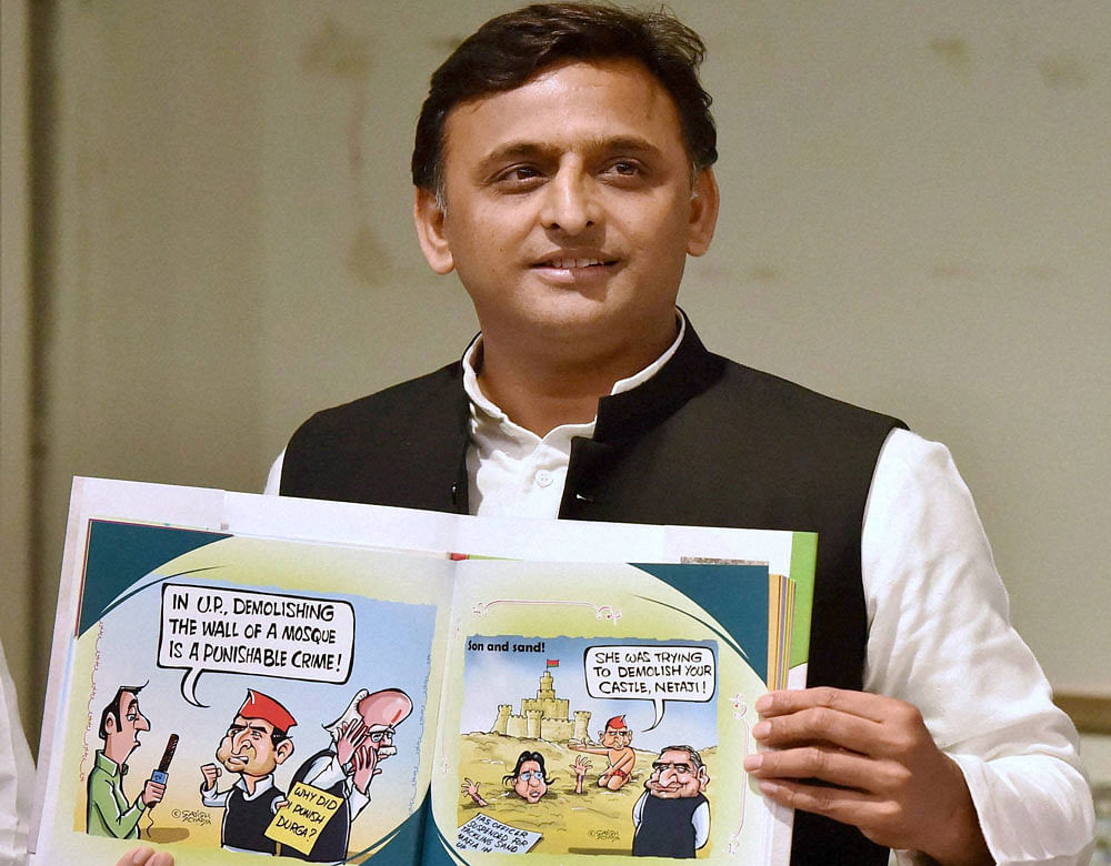 Uttar Pradesh Chief Minister Akhilesh Yadav releases a book 'Tipu ka Afsana' based on cartoons on him at Samajwadi Party headquarters in Lucknow on Monday. PTI Photo by Nand Kumar
