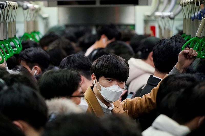 A man wearing a mask as a preventive measure against the coronavirus rides on a train in Seoul, South Korea. (Reuters Photo)